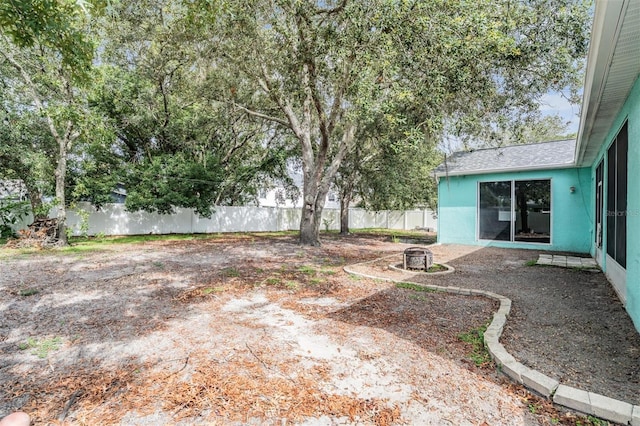 5283 Bevens Ave, Spring Hill, FL 34608 - fenced backyard with an outdoor fire pit