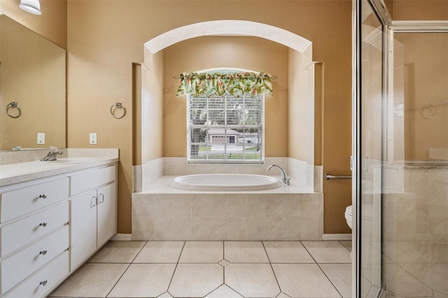 5283 Bevens Ave, Spring Hill, FL 34608 - bathroom featuring vanity, a garden tub, a shower stall, and tile patterned flooring