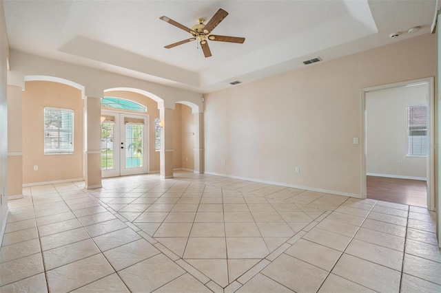 5283 Bevens Ave, Spring Hill, FL 34608 - unfurnished room with a raised ceiling, light tile patterned floors, french doors, and ceiling fan