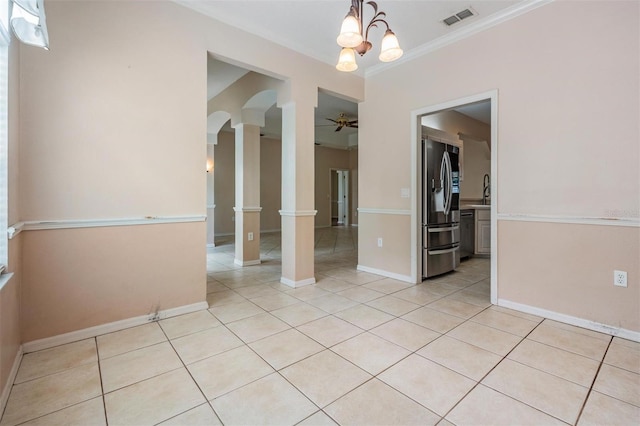 5283 Bevens Ave, Spring Hill, FL 34608 - spare room with ornamental molding, light tile patterned flooring, arched walkways, a ceiling fan, and ornate columns