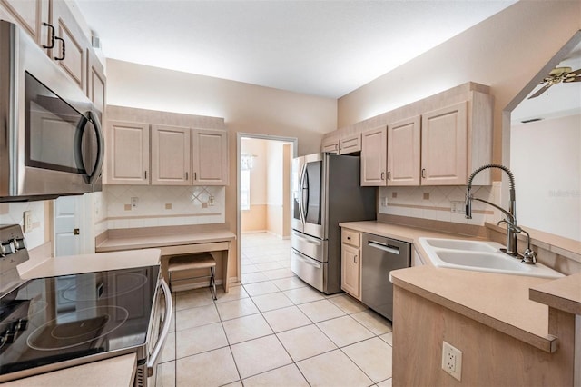 5283 Bevens Ave, Spring Hill, FL 34608 - kitchen featuring appliances with stainless steel finishes, tasteful backsplash, a peninsula, and light brown cabinetry