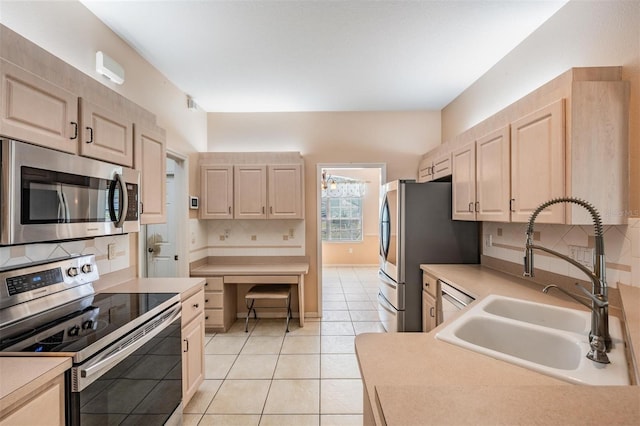5283 Bevens Ave, Spring Hill, FL 34608 - kitchen featuring stainless steel appliances, backsplash, light brown cabinets, light countertops, and light tile patterned flooring