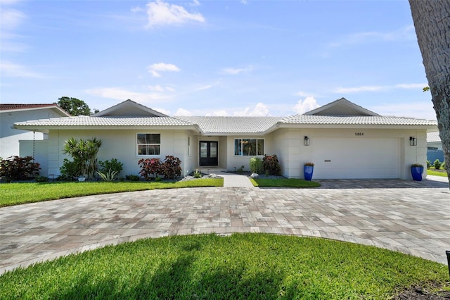 5884 51st St S, Saint Petersburg, FL 33715 - single story home with a garage, a tile roof, stucco siding, and decorative driveway