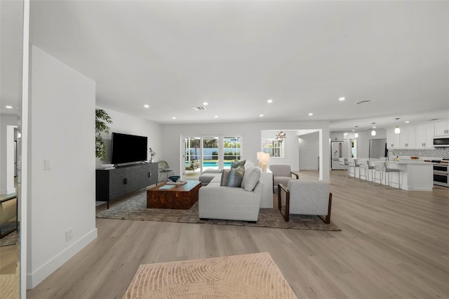 5884 51st St S, Saint Petersburg, FL 33715 - living room featuring recessed lighting and light wood-type flooring