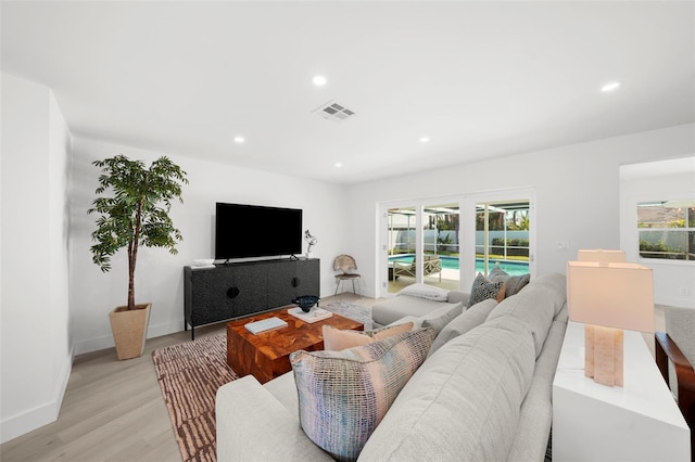 5884 51st St S, Saint Petersburg, FL 33715 - living area featuring healthy amount of natural light, light wood finished floors, and recessed lighting