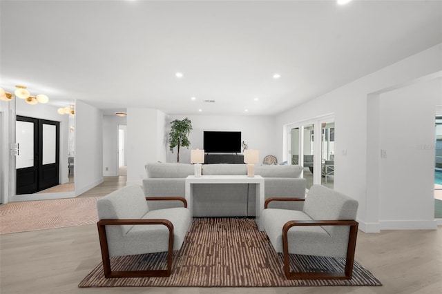 5884 51st St S, Saint Petersburg, FL 33715 - living room with french doors, light wood finished floors, recessed lighting, and plenty of natural light