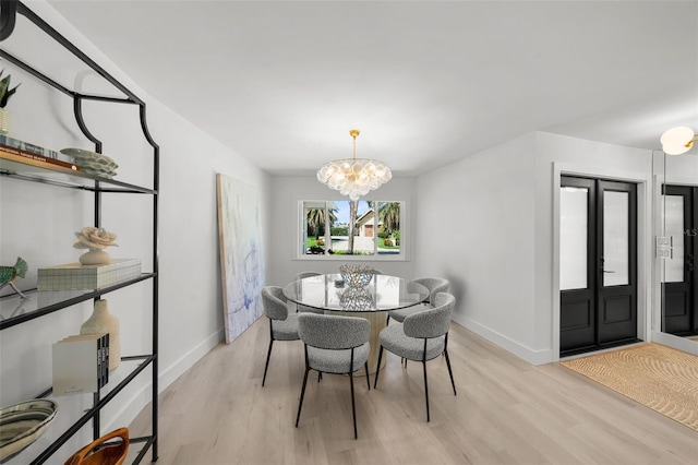 5884 51st St S, Saint Petersburg, FL 33715 - dining room with a chandelier and light wood-style floors