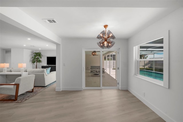 5884 51st St S, Saint Petersburg, FL 33715 - dining area with light wood-style floors, a chandelier, and recessed lighting