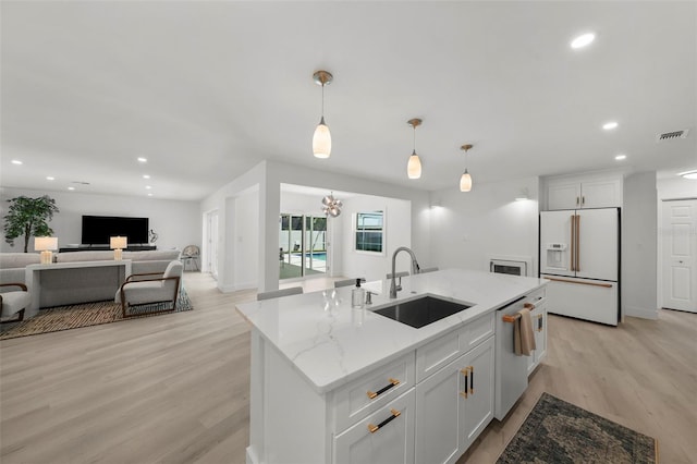 5884 51st St S, Saint Petersburg, FL 33715 - kitchen with white fridge with ice dispenser, open floor plan, light wood-style flooring, dishwasher, and recessed lighting