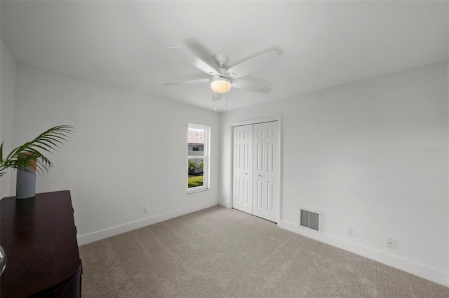 5884 51st St S, Saint Petersburg, FL 33715 - unfurnished bedroom featuring carpet, a closet, and ceiling fan