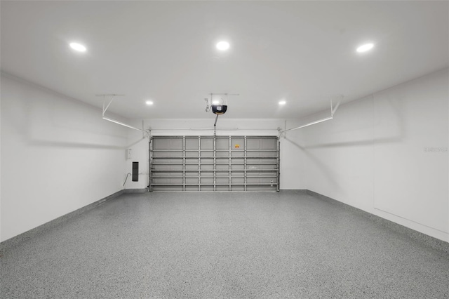 5884 51st St S, Saint Petersburg, FL 33715 - garage featuring a garage door opener and recessed lighting