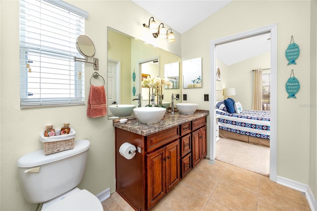 12337 Rose Haven Blvd, New Port Richey, FL 34654 - ensuite bathroom featuring vaulted ceiling, double vanity, and tile patterned flooring