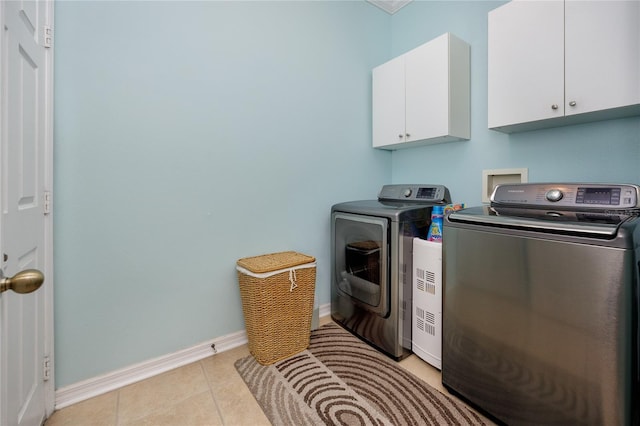 12337 Rose Haven Blvd, New Port Richey, FL 34654 - washroom featuring cabinet space, separate washer and dryer, and light tile patterned floors