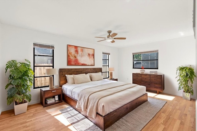 2233 Curlew Rd, Dunedin, FL 34698 - bedroom featuring multiple windows, light wood finished floors, and a ceiling fan