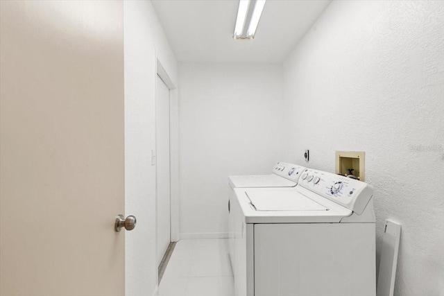 2233 Curlew Rd, Dunedin, FL 34698 - washroom with washer and dryer and baseboards