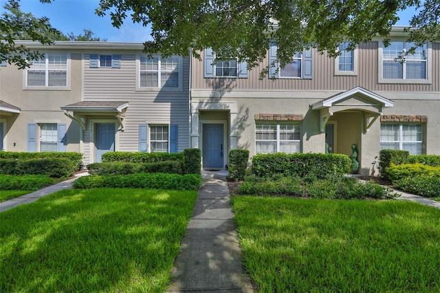 5717 Fishhawk Ridge Dr, Lithia, FL 33547 - view of property featuring a front lawn and stucco siding
