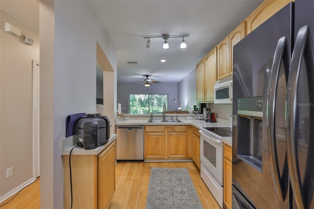 5717 Fishhawk Ridge Dr, Lithia, FL 33547 - kitchen featuring white appliances, light wood finished floors, a ceiling fan, and light countertops