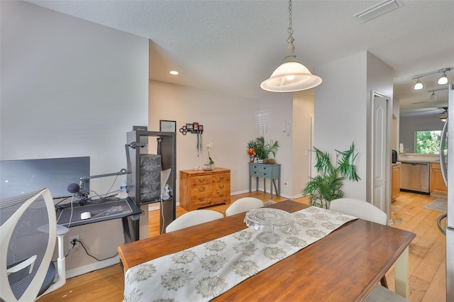 5717 Fishhawk Ridge Dr, Lithia, FL 33547 - dining room featuring light wood-style flooring, a textured ceiling, and recessed lighting