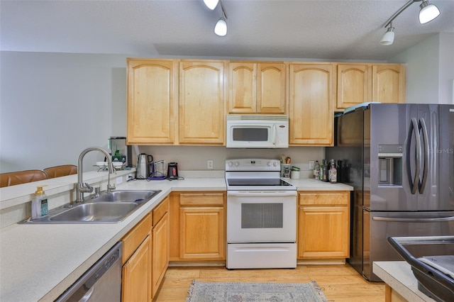 5717 Fishhawk Ridge Dr, Lithia, FL 33547 - kitchen featuring stainless steel appliances, light brown cabinets, light wood-style flooring, rail lighting, and a textured ceiling