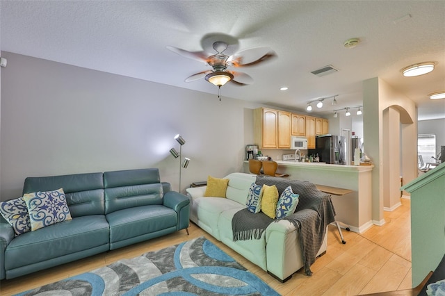 5717 Fishhawk Ridge Dr, Lithia, FL 33547 - living area with light wood-type flooring and a ceiling fan