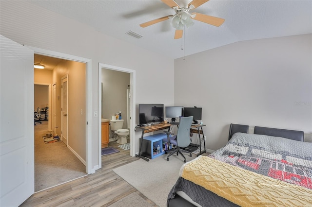 5717 Fishhawk Ridge Dr, Lithia, FL 33547 - bedroom with light wood finished floors, lofted ceiling, ceiling fan, an office area, and ensuite bath