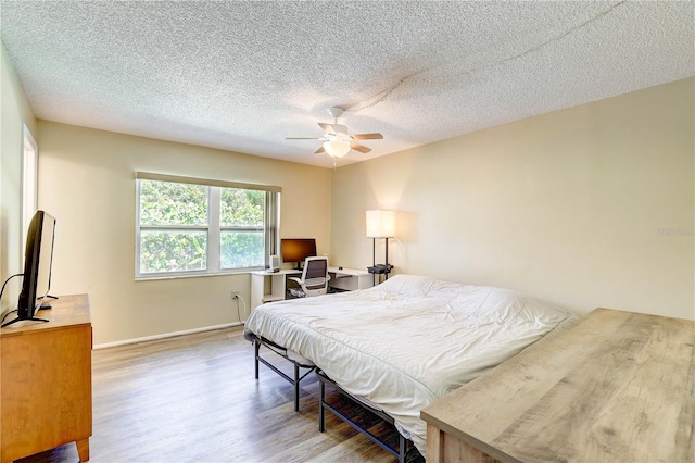 6865 Circle Creek Dr, Pinellas Park, FL 33781 - bedroom featuring wood finished floors, a textured ceiling, ceiling fan, and an office area