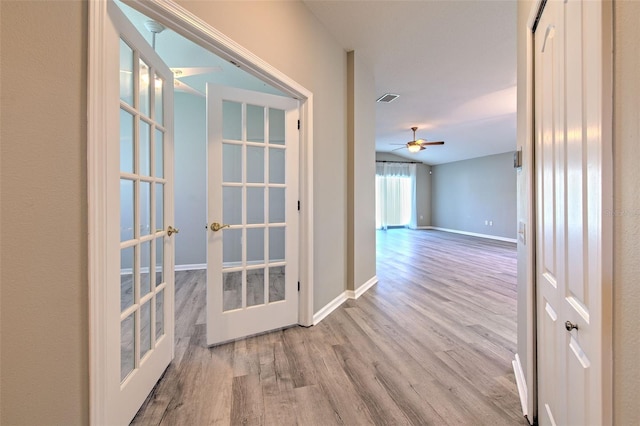 5046 Gato Del Sol Cir, Wesley Chapel, FL 33544 - corridor with french doors and wood finished floors