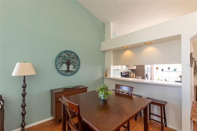 112 Sun Isle Cir Unit 112, Treasure Island, FL 33706 - dining room with wood finished floors and vaulted ceiling