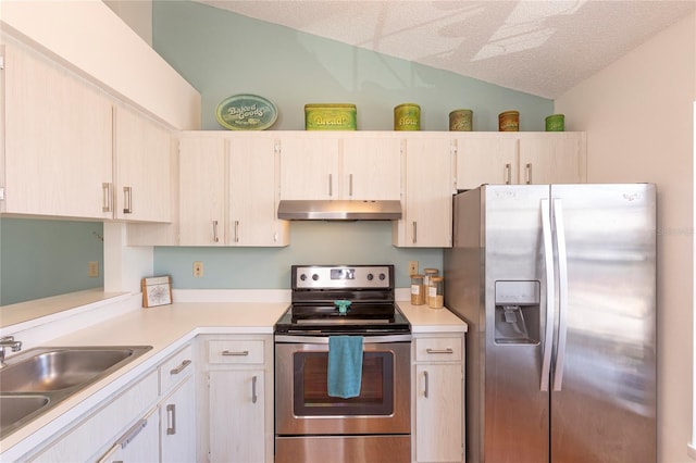 112 Sun Isle Cir Unit 112, Treasure Island, FL 33706 - kitchen with stainless steel appliances, under cabinet range hood, lofted ceiling, and light countertops