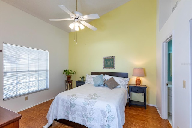 112 Sun Isle Cir Unit 112, Treasure Island, FL 33706 - bedroom with high vaulted ceiling, wood finished floors, and a ceiling fan