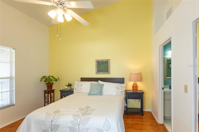 112 Sun Isle Cir Unit 112, Treasure Island, FL 33706 - bedroom with high vaulted ceiling, wood finished floors, and a ceiling fan
