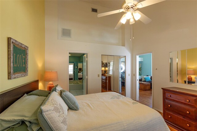 112 Sun Isle Cir Unit 112, Treasure Island, FL 33706 - bedroom featuring a high ceiling, ensuite bath, and ceiling fan