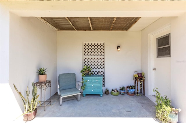 112 Sun Isle Cir Unit 112, Treasure Island, FL 33706 - doorway to property with stucco siding and a patio