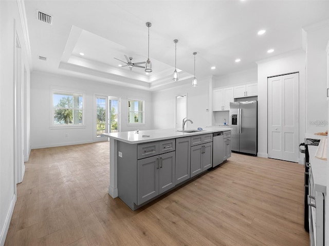 115 White Marsh Ln, Rotonda West, FL 33947 - kitchen featuring stainless steel appliances, gray cabinetry, crown molding, open floor plan, and light wood finished floors