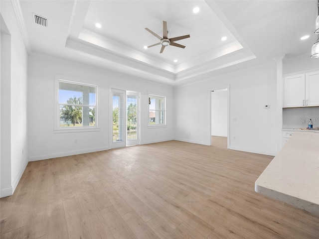 115 White Marsh Ln, Rotonda West, FL 33947 - unfurnished living room featuring ceiling fan, a tray ceiling, crown molding, light wood-type flooring, and recessed lighting