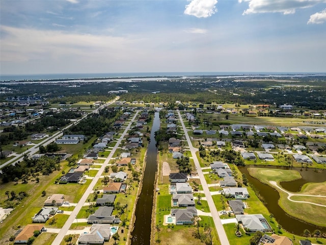 115 White Marsh Ln, Rotonda West, FL 33947 - aerial overview of property's location featuring a large body of water, nearby suburban area, and a golf course