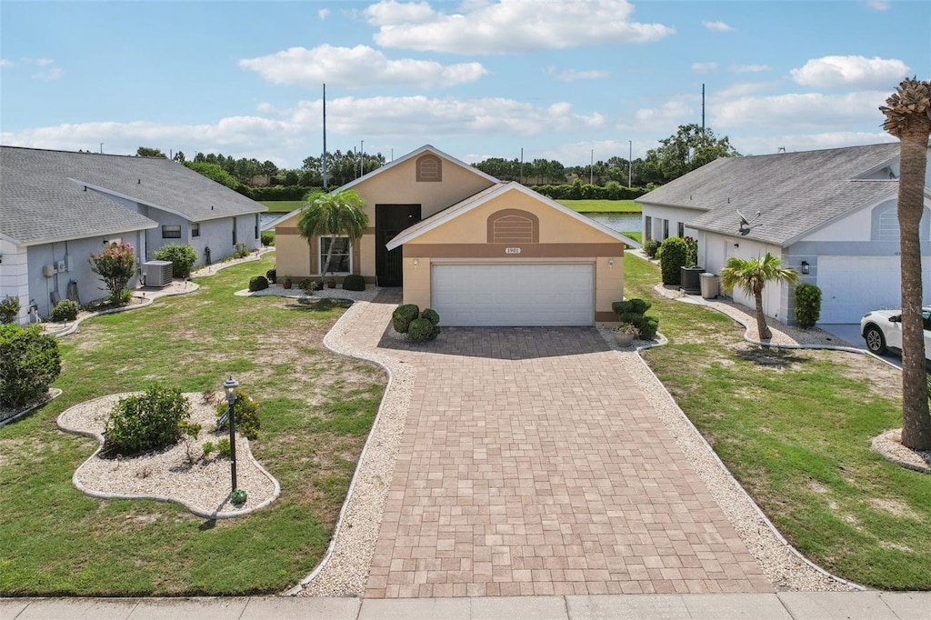 1901 E Del Webb Blvd, Sun City Center, FL 33573 - single story home with decorative driveway, stucco siding, an attached garage, and a front lawn