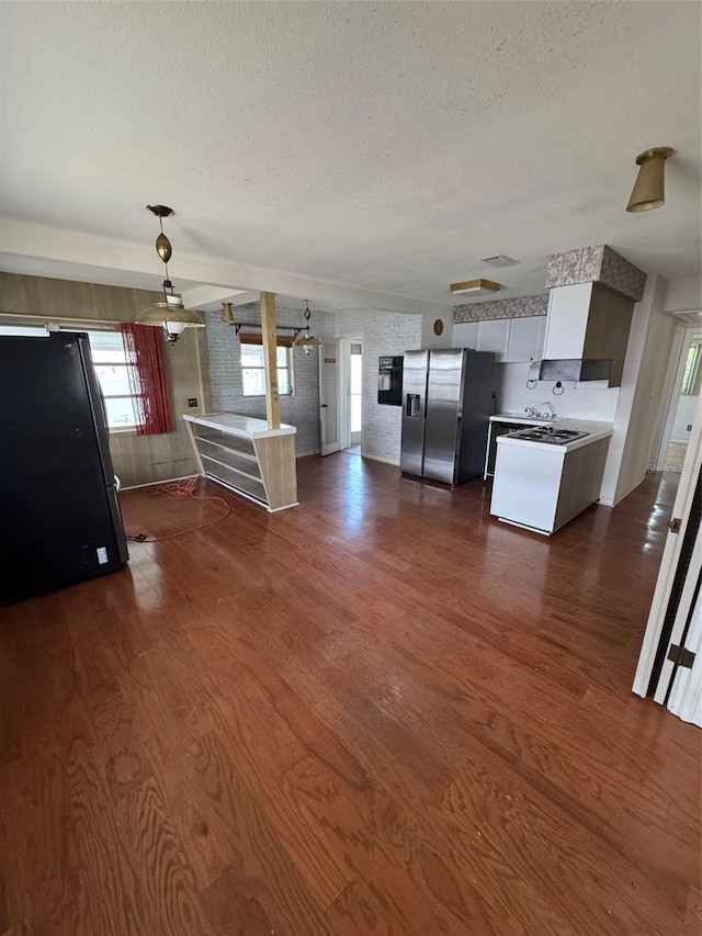 11423 77th Ave, Seminole, FL 33772 - kitchen featuring stainless steel fridge, freestanding refrigerator, a textured ceiling, range, and dark wood-type flooring