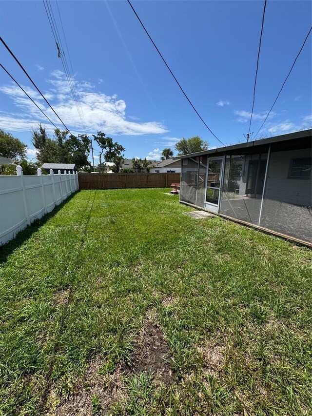 11423 77th Ave, Seminole, FL 33772 - fenced backyard featuring a sunroom