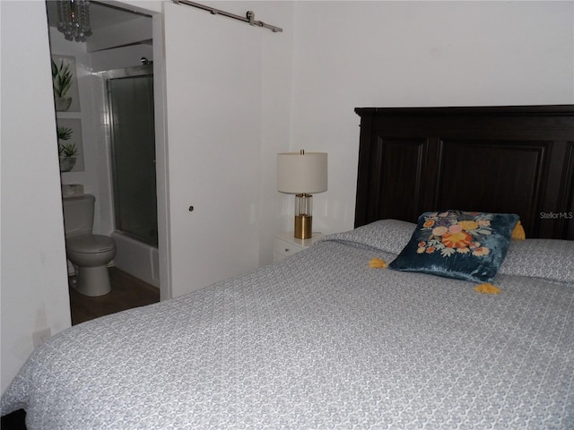 2617 Cove Cay Dr Unit 707, Clearwater, FL 33760 - bedroom featuring a barn door and wood finished floors
