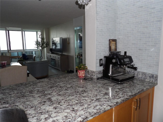 2617 Cove Cay Dr Unit 707, Clearwater, FL 33760 - kitchen featuring light stone counters and brown cabinets