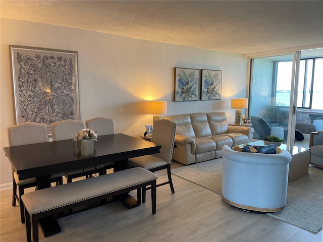 2617 Cove Cay Dr Unit 707, Clearwater, FL 33760 - living room featuring light wood-style floors, a textured ceiling, and floor to ceiling windows