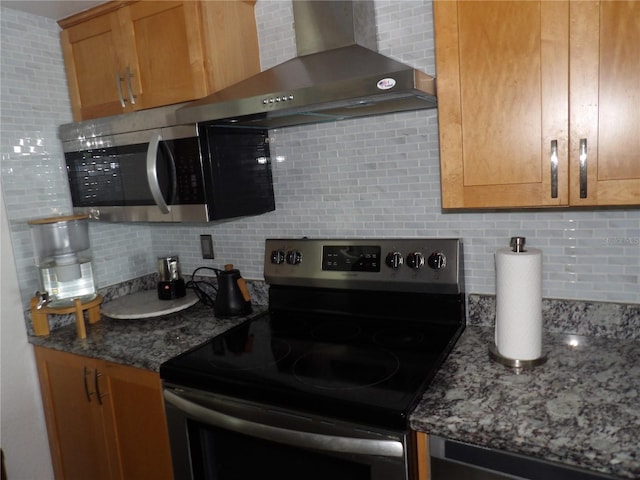 2617 Cove Cay Dr Unit 707, Clearwater, FL 33760 - kitchen with stainless steel appliances, wall chimney exhaust hood, decorative backsplash, and dark stone countertops
