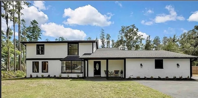 19003 Cedar Ln, Lutz, FL 33548 - view of front facade with stucco siding and a front yard