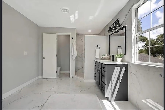 19003 Cedar Ln, Lutz, FL 33548 - bathroom featuring vanity, a marble finish shower, and marble finish floors