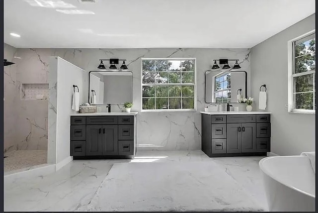 19003 Cedar Ln, Lutz, FL 33548 - bathroom featuring marble tiled floors, a marble finish shower, two vanities, and healthy amount of natural light