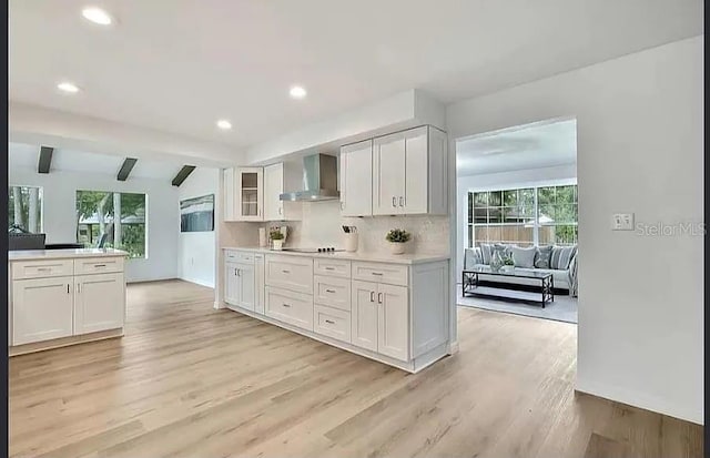 19003 Cedar Ln, Lutz, FL 33548 - kitchen featuring wall chimney exhaust hood, healthy amount of natural light, white cabinetry, and recessed lighting