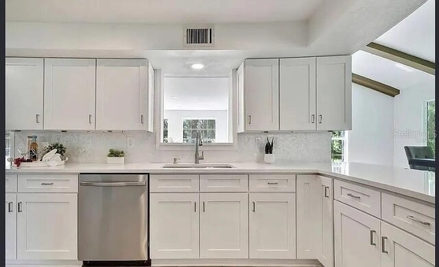 19003 Cedar Ln, Lutz, FL 33548 - kitchen featuring dishwasher, light countertops, and white cabinetry
