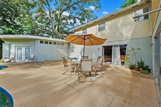14803 Tulip Dr, Tampa, FL 33613 - view of patio with french doors and outdoor dining space