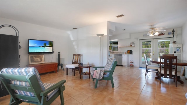 2807 Miriam St S, Gulfport, FL 33711 - living area with french doors, light tile patterned floors, and a ceiling fan